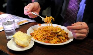 A diner twirls his spaghetti at Pellegri