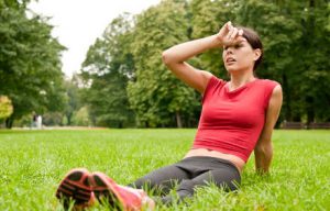 Relax in grass - tired woman after sport