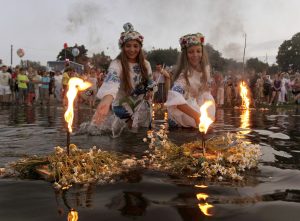 Image: Belarusian girls float wreaths with candles as they take part in the Ivan Kupala festival in the town of Turov