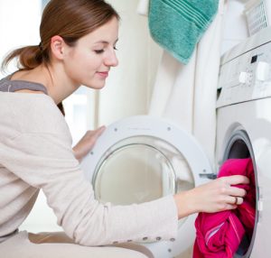 Housework: young woman doing laundry