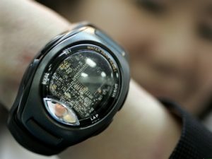 An employee of Japan's AR'S Corporation shows-off the company's wrist-type wearable miniature sensin..