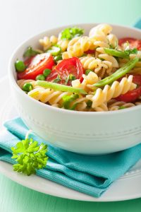 43492862 - vegetarian pasta fusilli with tomato peas herbs